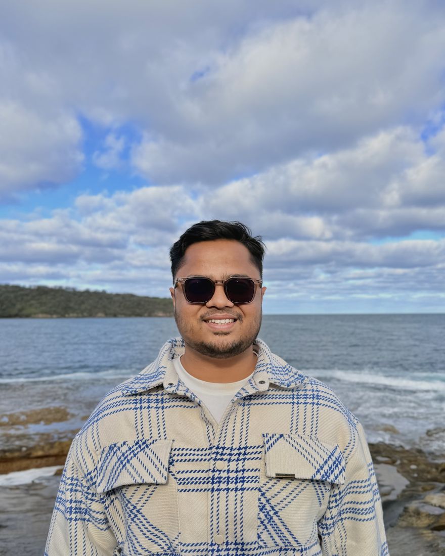Rafeed Mohammad Sultan standing on a rocky coastline near Sydney.